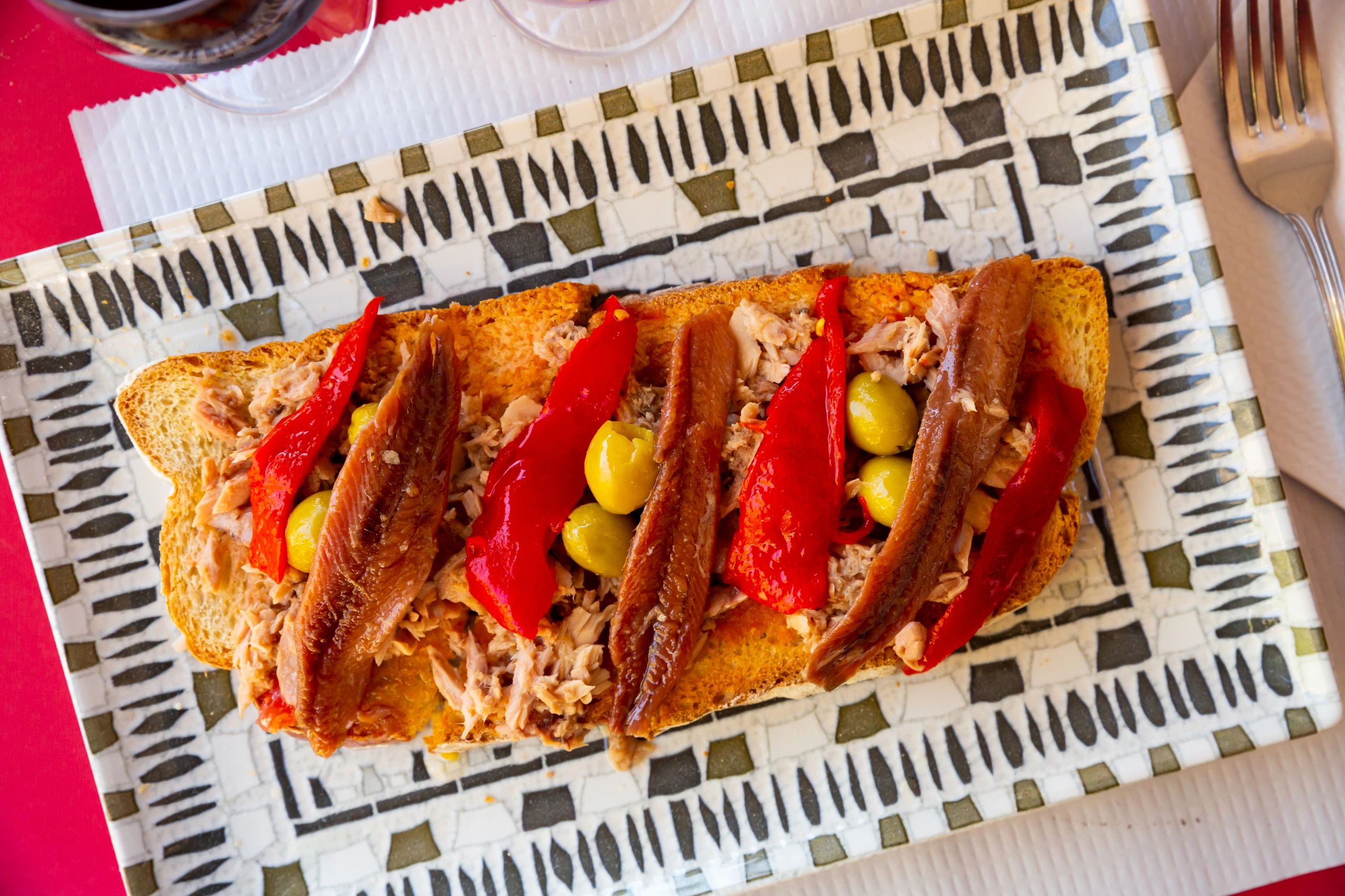Iberian-style plated toast with anchovies and peppers