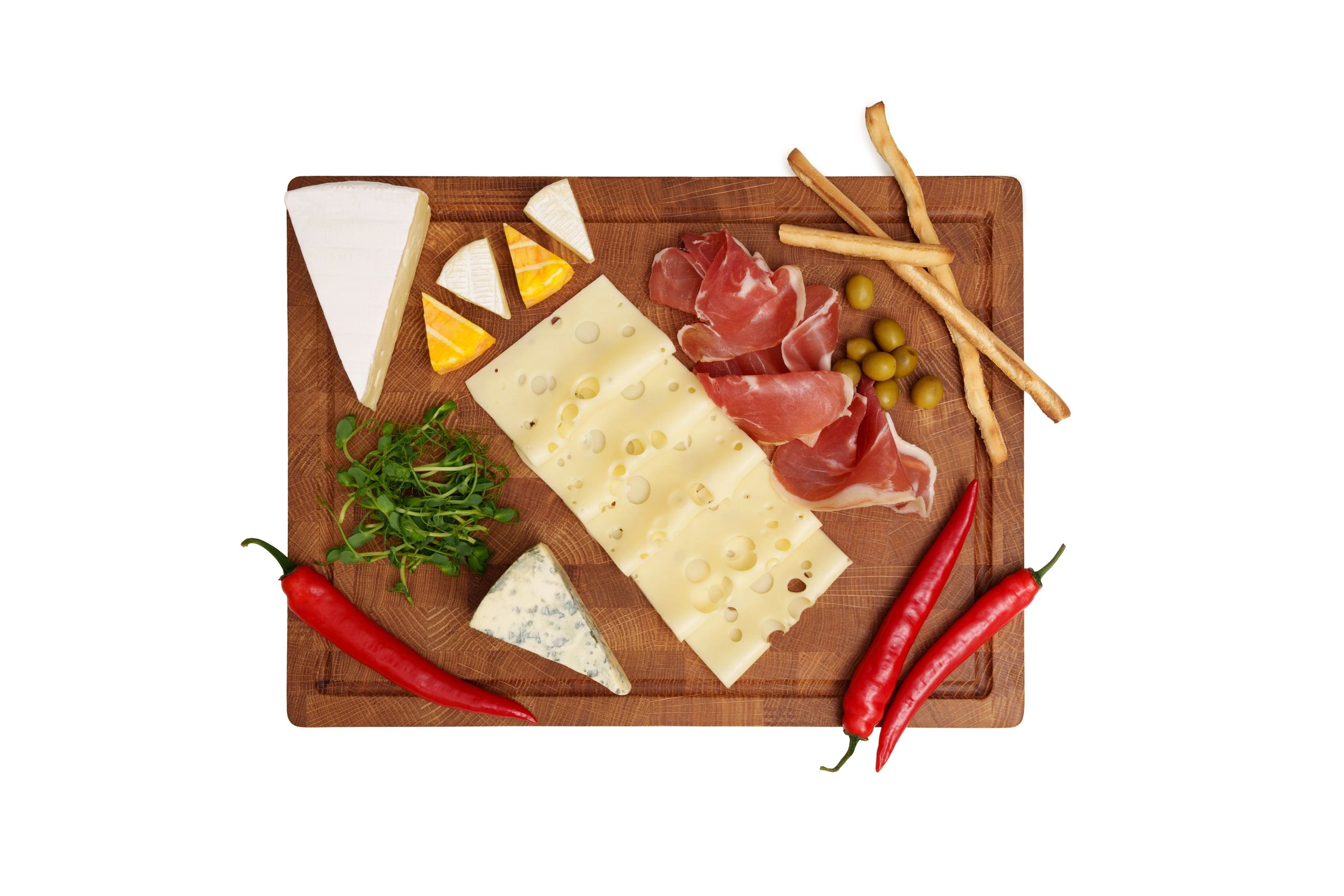 Cheese board with jamon, olives, breadsticks, and assorted cheeses