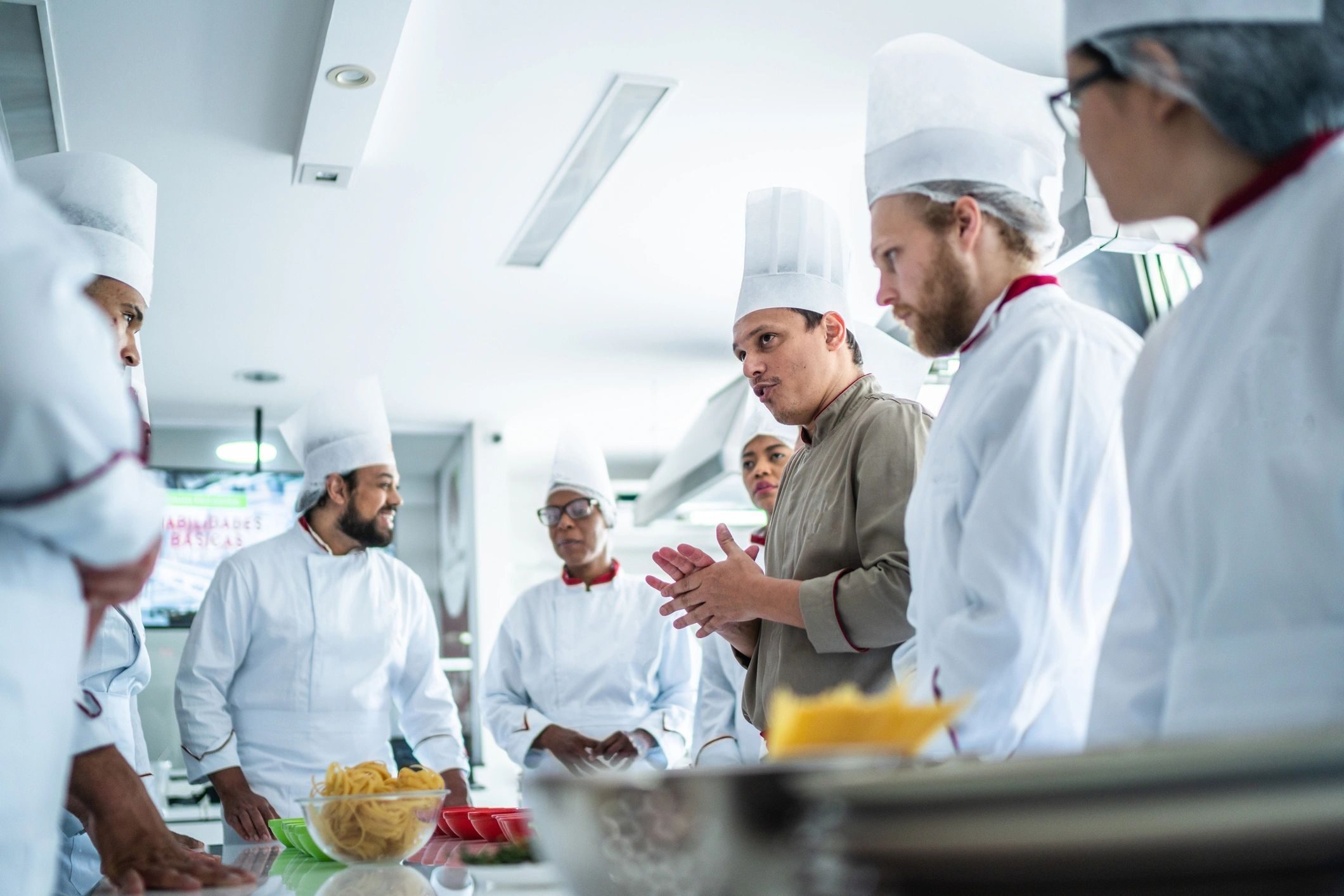 Chef teaching students during cooking class